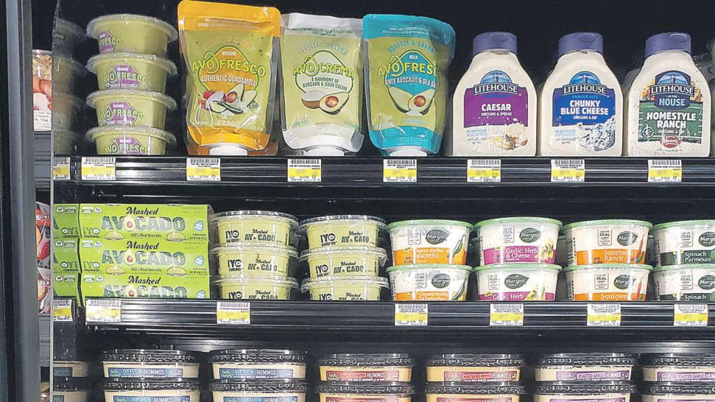 European supermarket refrigerated section displaying various guacamole products