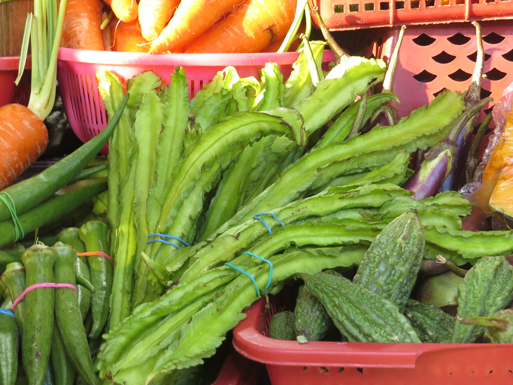 Tropical vegetable market displaying fresh winged bean pods with distinctive four-winged edges