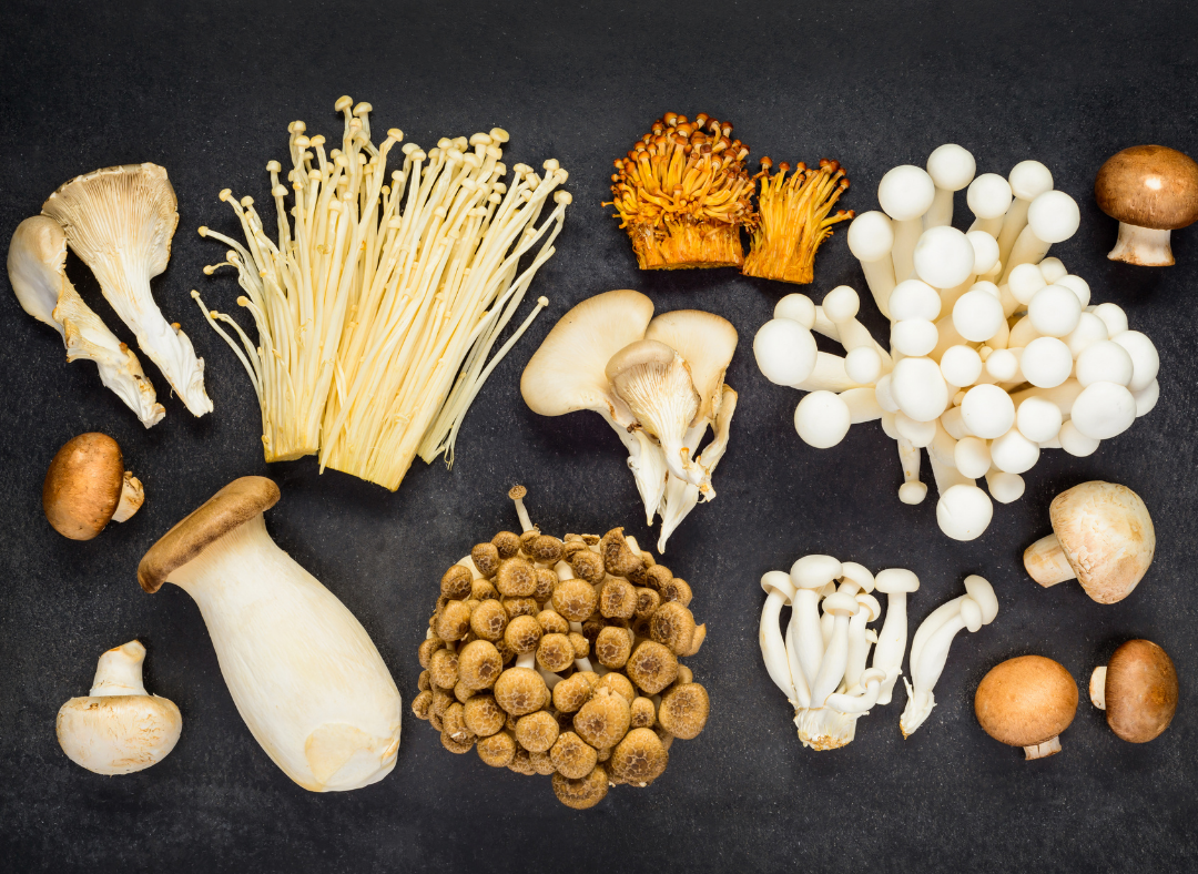 Various fresh mushroom varieties including button cremini portobello shiitake oyster showing different types and quality grades per kilogram